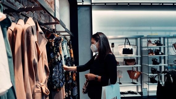 Photo of a female shopping for clothing in a physical store