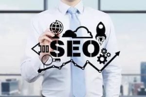 Illustration/photo of a male pointing at an SEO graphic